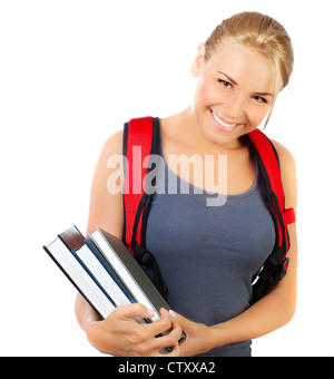 Female student holds books isolated on yellow background in studio ...