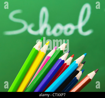 Back to school concept, green chalkboard with handwriting and set of colorful drawing pencils Stock Photo