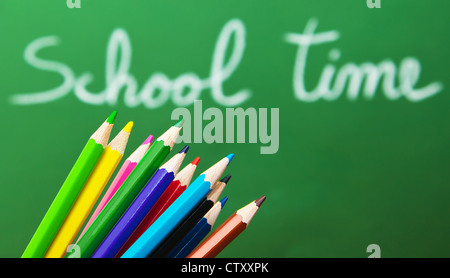 Back to school concept, green chalkboard with handwriting and set of colorful drawing pencils Stock Photo