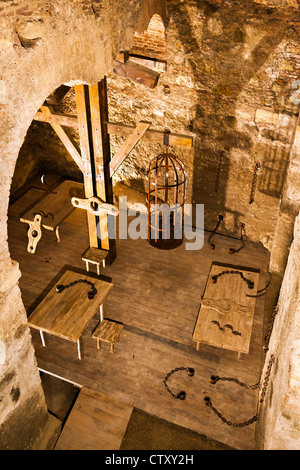 Holding cell in a medieval prison, with torture instruments Stock Photo