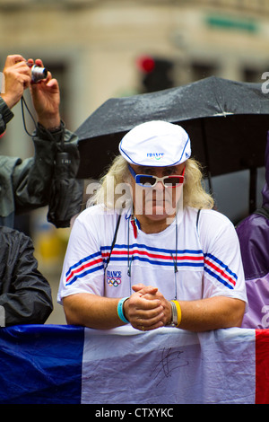 French athletics supporter waits in rain for women's Marathon, Olympic Games, London, 2012. Stock Photo