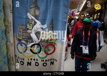 In the local community Stratford Centre shopping mall in East London, we see official Olympic merchandising on sale during the London 2012 Olympics, the 30th Olympiad. A few hundred metres from the giant Westfield plaza complex that acts as a gateway to the main Olympic arenas, this market outdates the newer development where similar souvenirs can be bought for up to twice the prices offered by the stall holder. Cashions are £10 (Pounds) and duvet covers (bedding) are £20. Stock Photo