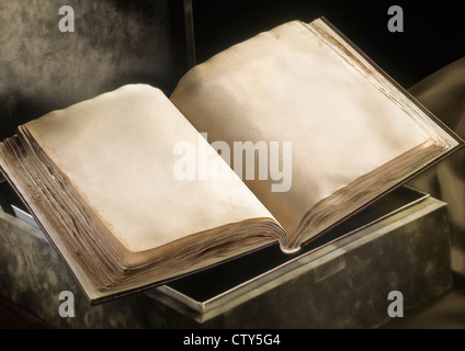 Old book open laying on a box with two blank pages. Real ancient texture Stock Photo