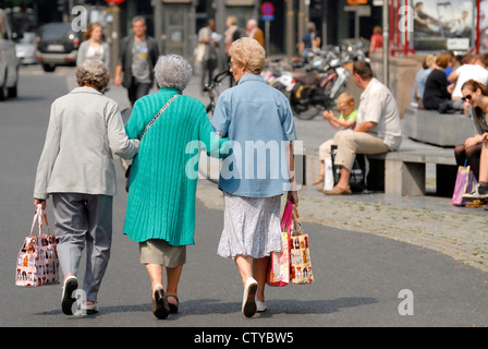 Antwerp / Antwerpen, Belgium. Three old women walking arm in arm Stock Photo