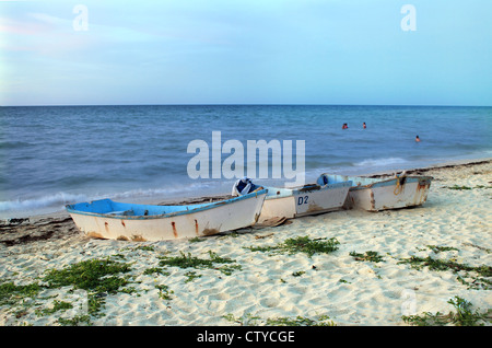 Empty rowboats with resting on sandy beach in Progreso, Yucatan, Mexico Stock Photo