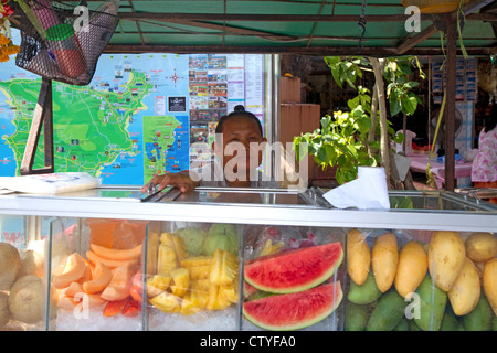 Street food vendors selling fruit at Chaweng beach village on the island of Ko Samui, Thailand. Stock Photo