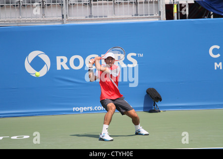 man playing tennis backhand return court outdoor Stock Photo