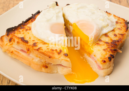 Classic French toasted sandwich or Croque Madame sliced in half with a fried egg on top of the toasted cheese - studio shot Stock Photo