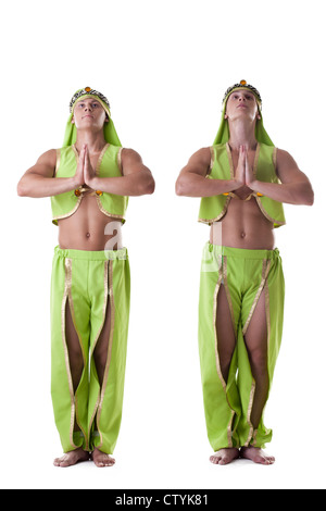 Two athletic man posing in arabian costume dancers isolated Stock Photo