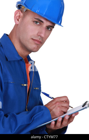 Inspector writing on clip-board Stock Photo