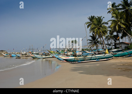 Outrigger fishing boats (oru or sea canoes) on beach, Kumarakanda, Sri Lanka Stock Photo