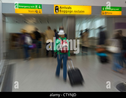 International airline passengers arriving at London Heathrow airport heading for arrivals and baggage reclaim areas Stock Photo