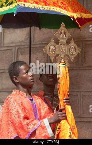 Young priests with Ethiopian cross at a religious procession, in Ethiopia, Africa. Stock Photo