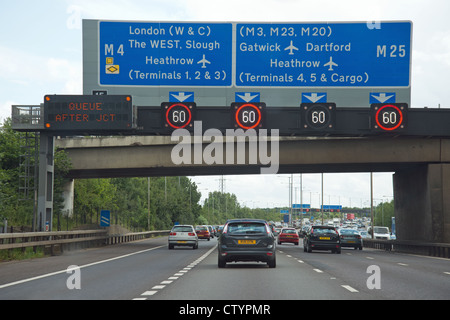 M4 Junction on M25 Motorway showing speed restrictions, Surrey, England ...