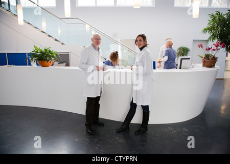 Make and female doctor at reception in a modern private clinic Stock Photo