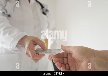 Doctor giving prescription medication to patient Stock Photo