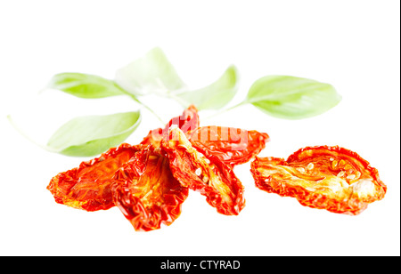 sun-dried tomatoes with basil leaves, isolated on white Stock Photo