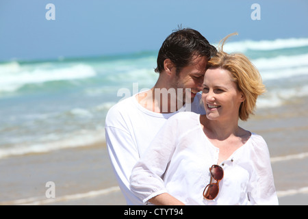 Couple embracing on the beach Stock Photo