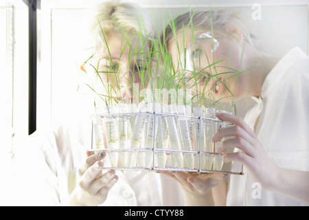 Scientists examining test tubes in lab Stock Photo