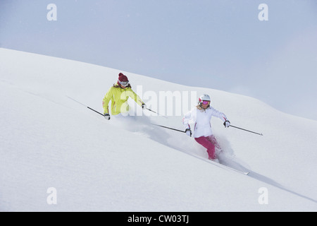 Skiers coasting on snowy slope Stock Photo