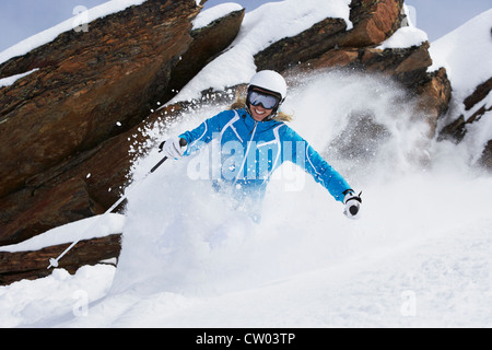 Skier coasting on snowy slope Stock Photo
