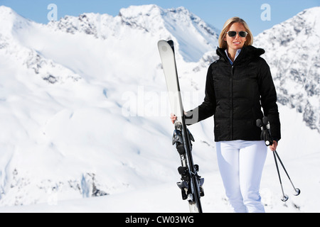 Skier standing on snowy mountain Stock Photo