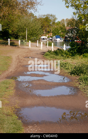 Footpath with big puddles after rain Stock Photo