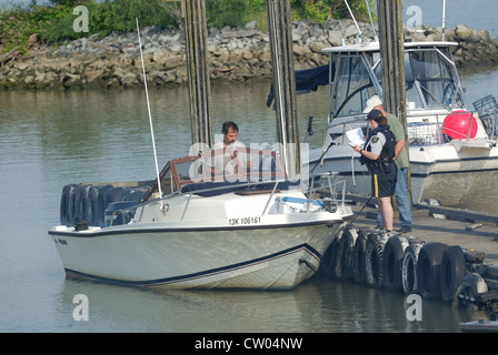 Rcmp Inspection RCMP officer doing a safety inspection on Pleasure craft Stock Photo ...
