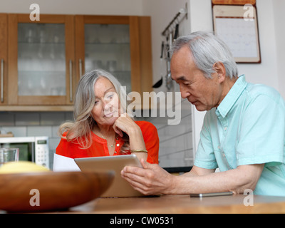 Older couple using tablet computer Stock Photo