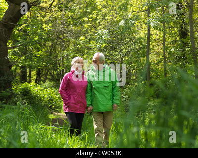 Older couple walking in forest together Stock Photo