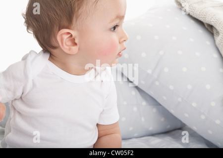 Baby crawling on couch Stock Photo