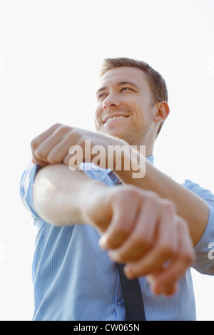Businessman rolling up sleeves Stock Photo