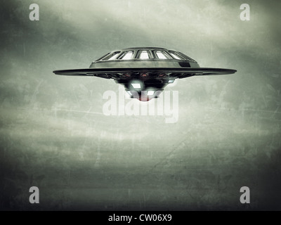 ufo spaceship vessel flying in cloudy sky Stock Photo