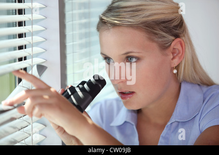 A nosy woman spying Stock Photo