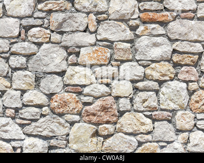 Block stone wall made from irregular sized stone blocks Stock Photo