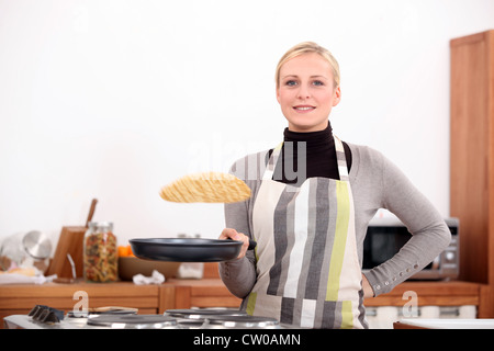 Woman making pancakes Stock Photo