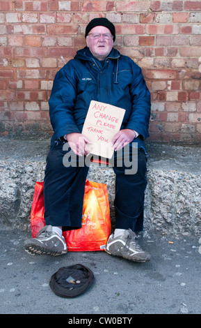 Elderly man asking for help at London West end, UK. Charity giving. Stock Photo