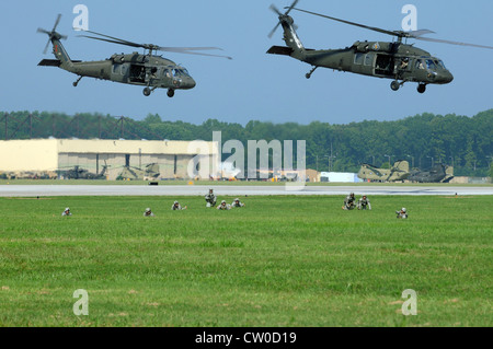 Soldiers with the 4th Brigade Combat Team leapfrog forward after air assaulting out of the 159th Combat Aviation Brigade's UH-60 Blackhawk helicopters during a practice at Campbell Army Airfield Tuesday. This demonstration was a rehearsal for the air assault that will occur Saturday as part of the Fort Campbell air show, which begins at 10 a.m. Stock Photo