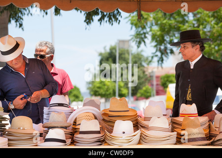 Market stall in Cordoba Andalusia Andalucia Spain.Hatter selling modern and traditional man's hats. Stock Photo