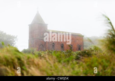 Old Catholic church covered in clouds on Bokor Hill Station (Bokor National Park) - Kampot Province, Cambodia Stock Photo