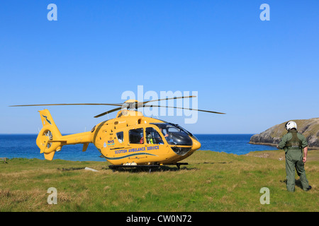 Scottish Air Ambulance Service Helicopter preparing to take off after a rescue mission on remote North West Highlands coast. UK Stock Photo
