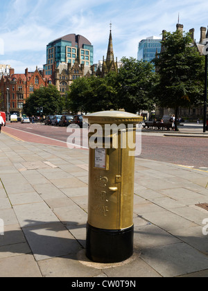 Postbox painted gold in honour of Greater Manchester cycling stars Philip Hindes and Jason Kenny in Manchester UK Stock Photo