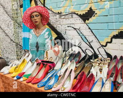 Table in flea market Hausmania in Oslo Norway with used shoes and other goods for sale Stock Photo