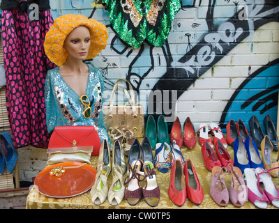 Table in flea market Hausmania in Oslo Norway with used shoes and other goods for sale Stock Photo