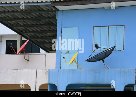 Closeup different styles of satellite dishes attached on building wall Stock Photo