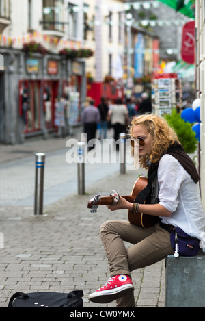 Busker in Latin quarter of Galway City, County Galway, Republic of Ireland. Stock Photo