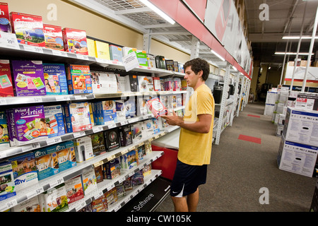 Eighteen year old college freshman shops at office supply store for computer software Stock Photo