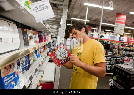 Eighteen year old college freshman shops at office supply store for computer software Stock Photo