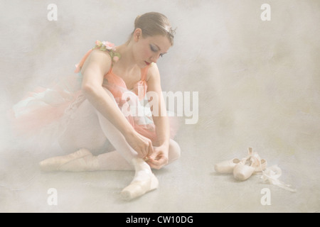 Artistic Rendering of Young Ballerina Tying Her Ballet Slippers Stock Photo