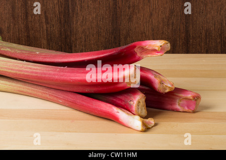 Rhubarb stalks grouped on a wooden table Stock Photo